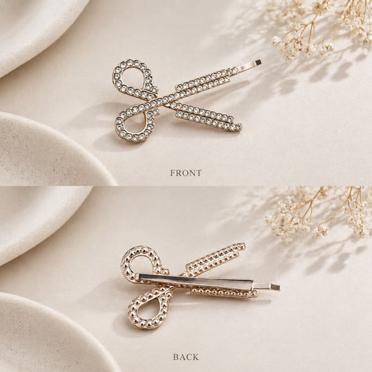 Gold Scissor shaped hairpin with rhinestones on a beige fabric background - Snug Strands