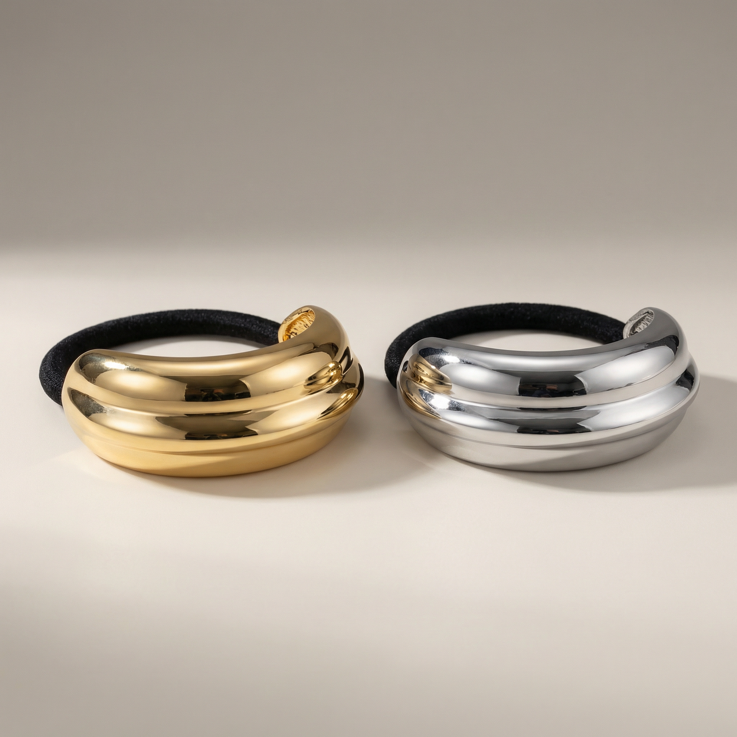 Two pony cuff , one gold and one silver, on a neutral background - Snug Strands